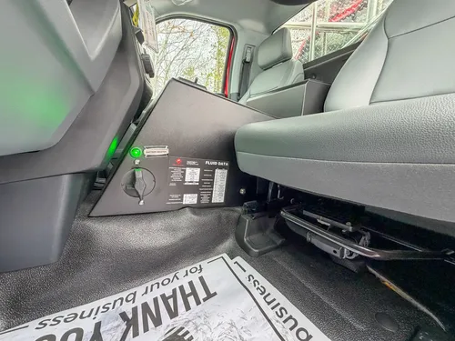 Rear cabin floor area with control box and wiring access panel.